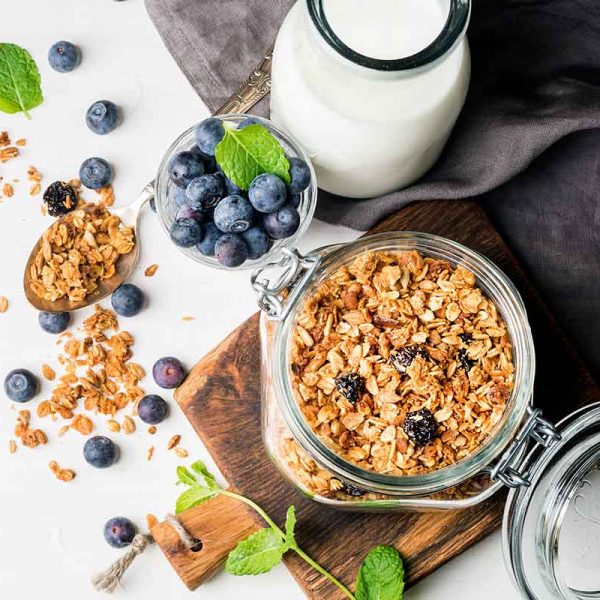 oats in a glass jar, blueberries and a bottle of milk