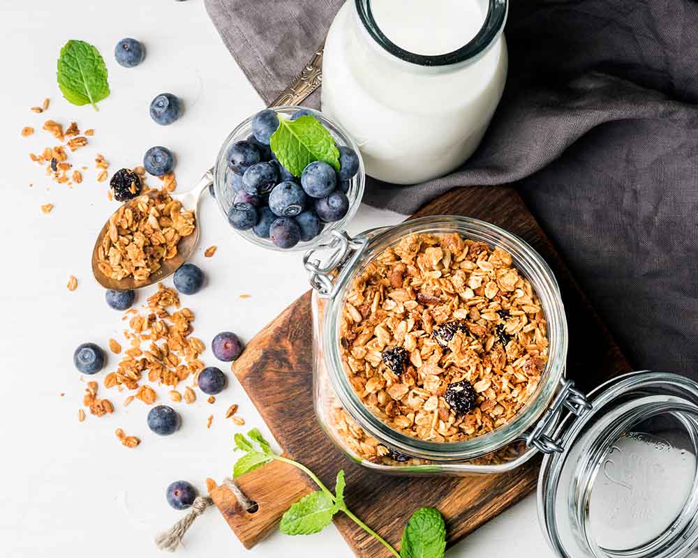 oats in a glass jar, blueberries and a bottle of milk