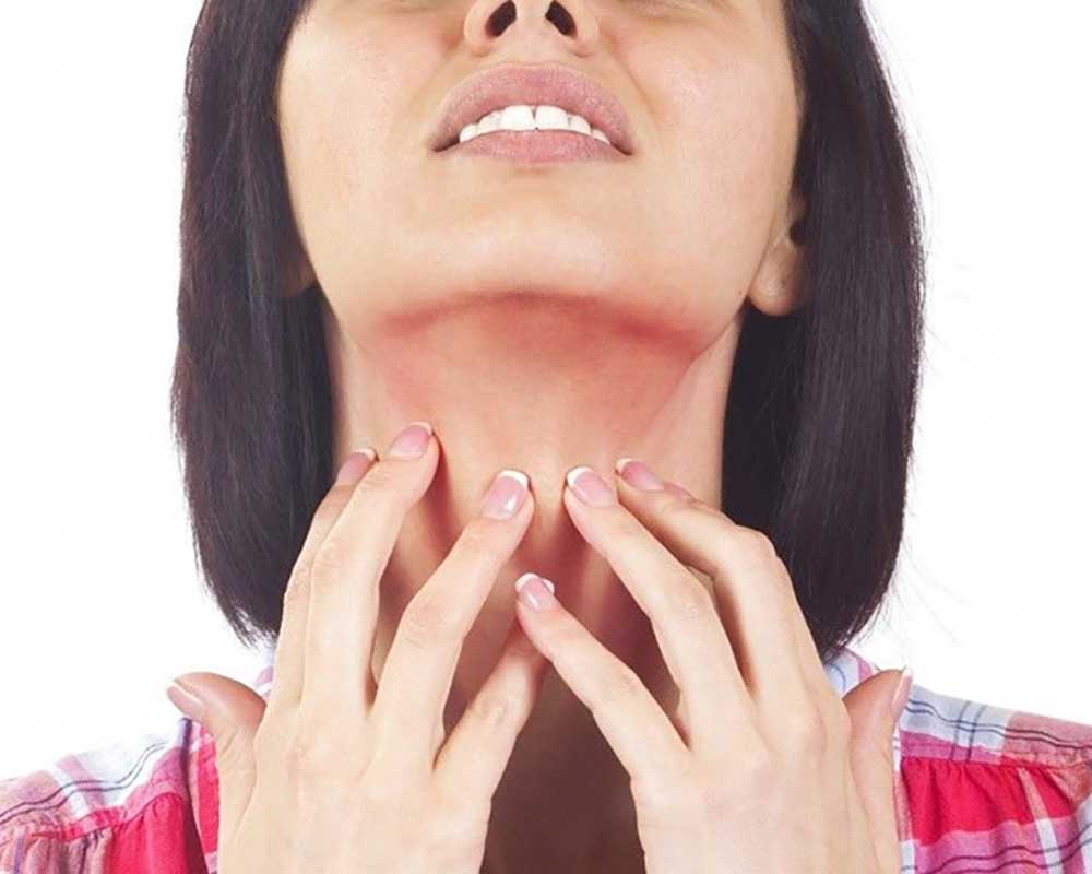Woman scratching her throat
