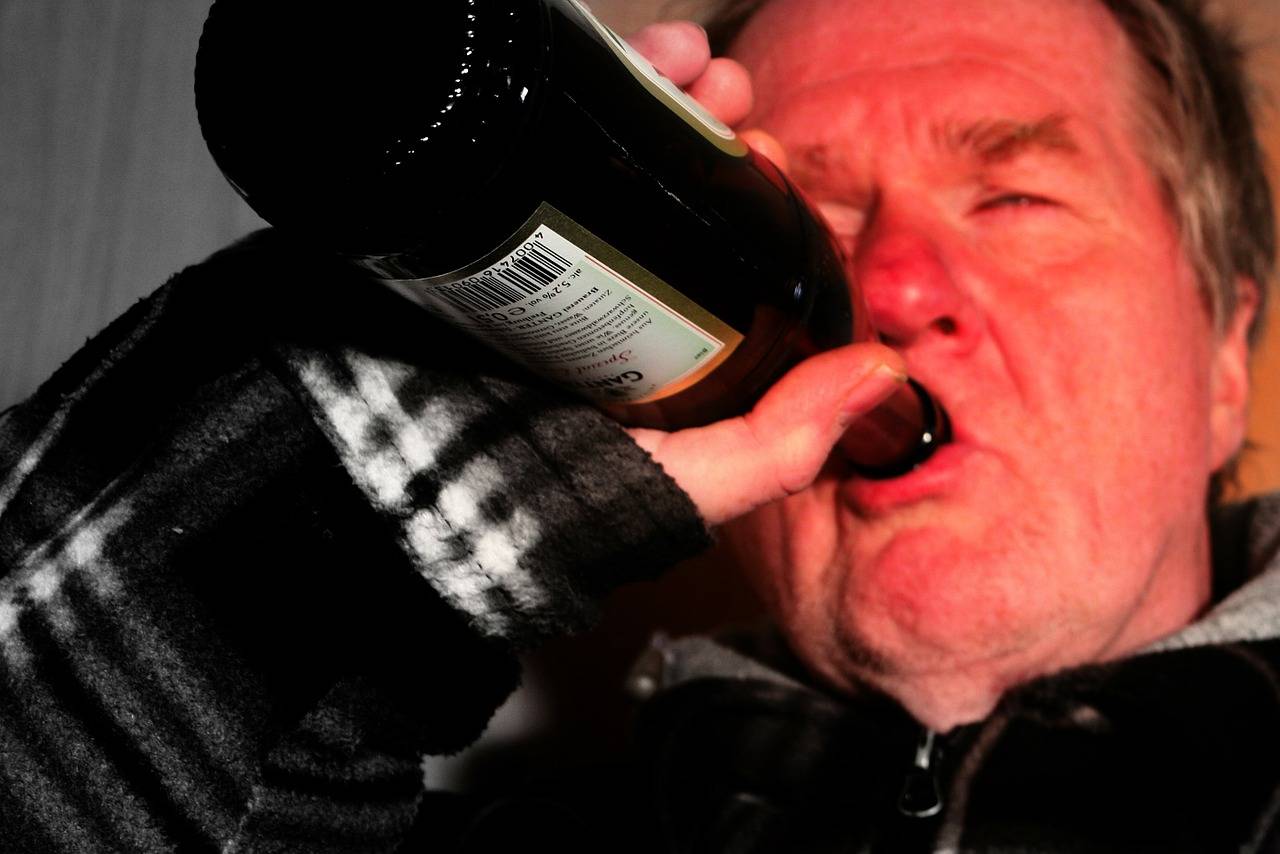 old man drinking a bottle of wine