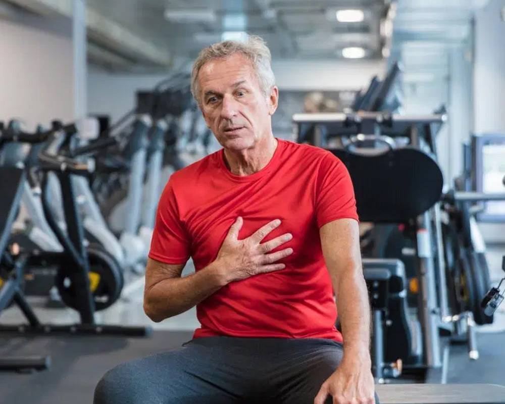 Ascites-Holder guy in the gym having chest pain