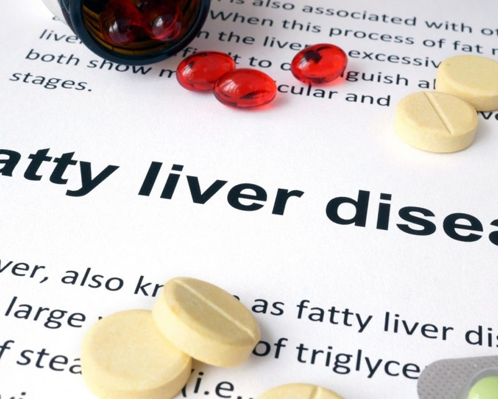 Fatty liver disease text and assorted pills