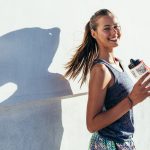 Fit woman holding water bottle