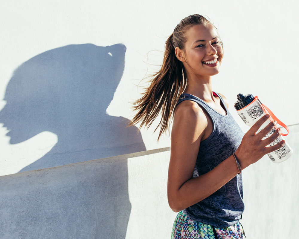 Fit woman holding water bottle
