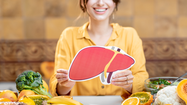Lady holding a photo of healthy liver